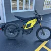 NIU XQi3 for sale Australia, Mix yellow and black color bike standing outside of a legal motorcycle shop