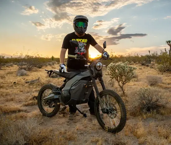 A person looking like a bike rider dress with helmets, holding a Caofen F80 DS-48 ready to go Trailing